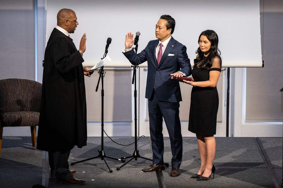 Sacramento District Attorney Thien Ho is sworn into oath by Judge Carlton Davis, while standing with his wife Jenny, on Tuesday. He is County’s 36th district attorney and the first person of color to hold the post.