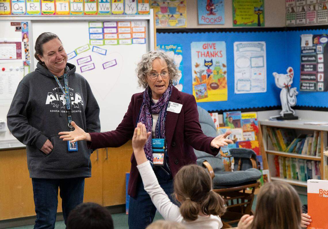 Linda LoBue, right, founder of Sight Word Busters, stands with first grade teacher Amanda Robinson, while talking to her students at Sierra Hills Elementary School in Meadow Vista earlier this month. Her organization helps 3,000 students annually learn to master “sight” words.