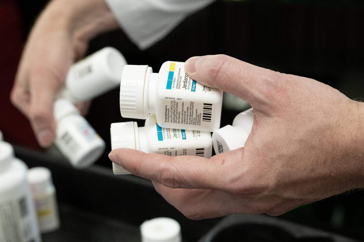 Pucci’s Pharmacy pharmacist and CEO Clint Hopkins stocks shelves with medications on Friday, Nov. 14, 2025, in Sacramento. California recently passed legislation restricting pharmacy benefit managers, a move intended to help small, independent pharmacies like his stay open.