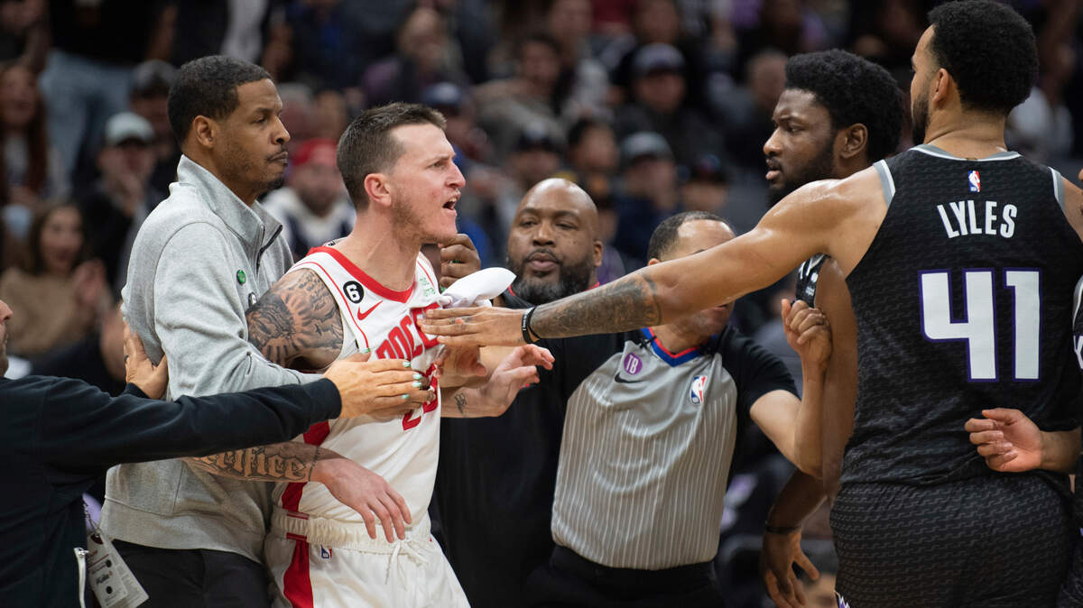Houston Rockets guard Garrison Mathews (25) is restrained by Rockets coach Stephen Silas as Mathews yells at Sacramento Kings forward Chimezie Metu and forward Trey Lyles (41) during the second half of an NBA basketball game in Sacramento, Calif., Friday, Jan. 13, 2023. The Kings won 139-114. (AP Photo/José Luis Villegas)