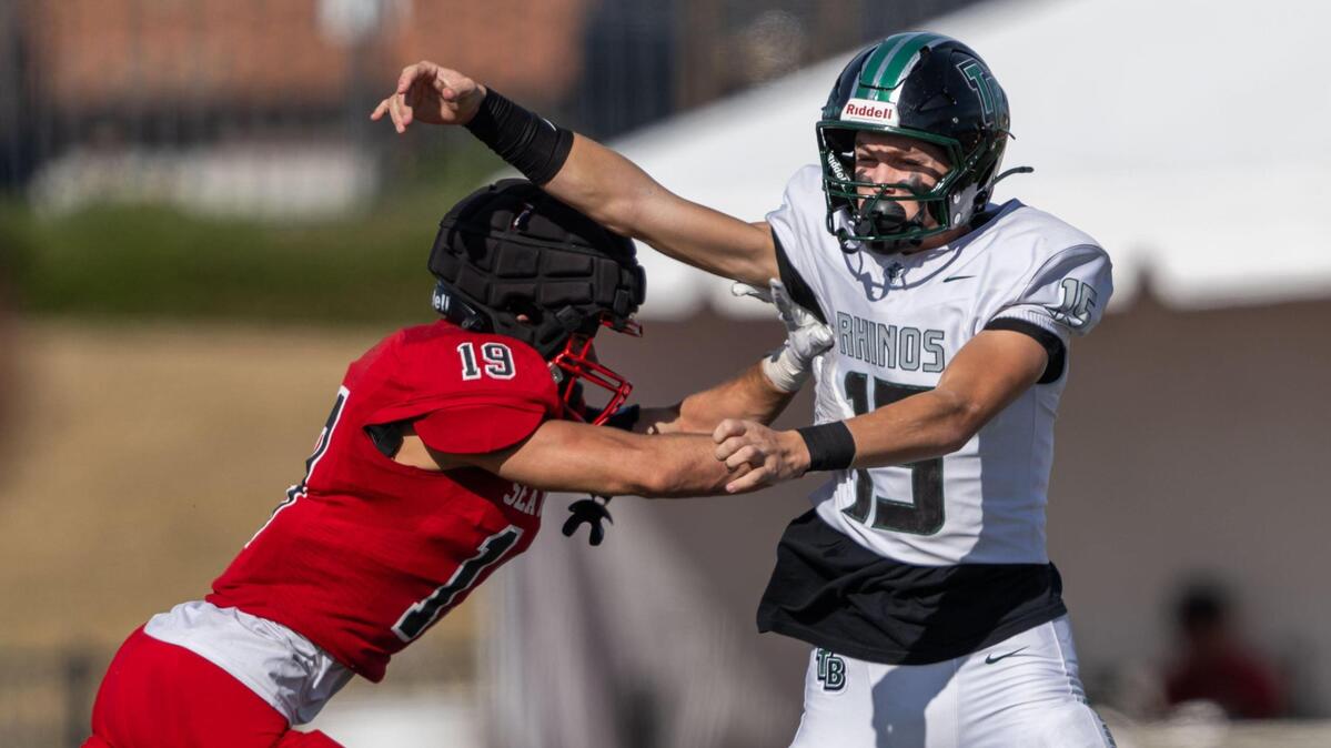 The Palos Verdes Sea Kings’ Owen Wishner (19) forces the Twelve Bridges Raging Rhinos’ Connor Flaherty (15) to throw a pass that was intercepted during the CIF State Division 2-A championship at Saddleback College in Mission Viejo on Saturday.