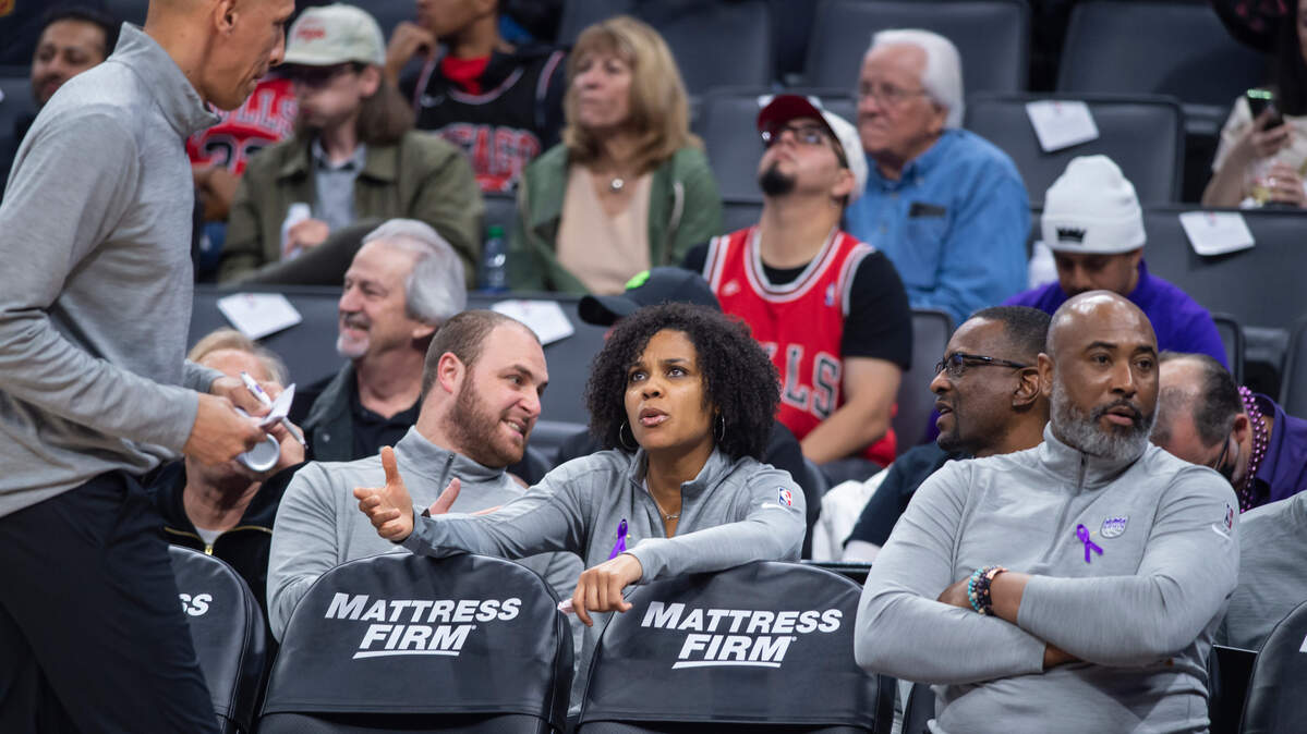 Lindsey Harding, center, assistant coach, talks with Doug Christie, left, after a timeout during the first quarter on Monday, March 14, 2022 during an NBA basketball game at the Golden 1 Center in Sacramento. The Kings defeated the Bulls 112-103.