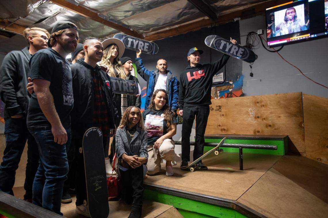 Friends of Sacramento native Tyre Nichols, most of them known through skateboarding, stand together for a photo at Sac Ramp Skate Shop on Feb. 4 during a memorial and celebration of life. Some of them hold up skateboards designed in memory of Nichols, who was beaten by Memphis police in January and later died.