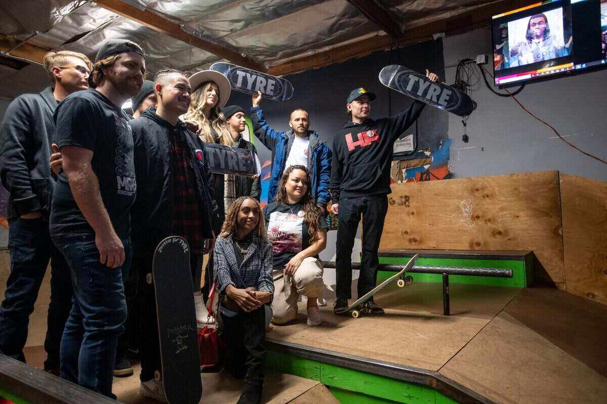 Friends of Sacramento native Tyre Nichols, most of them known through skateboarding, stand together for a photo at Sac Ramp Skate Shop on Feb. 4 during a memorial and celebration of life. Some of them hold up skateboards designed in memory of Nichols, who was beaten by Memphis police in January and later died.