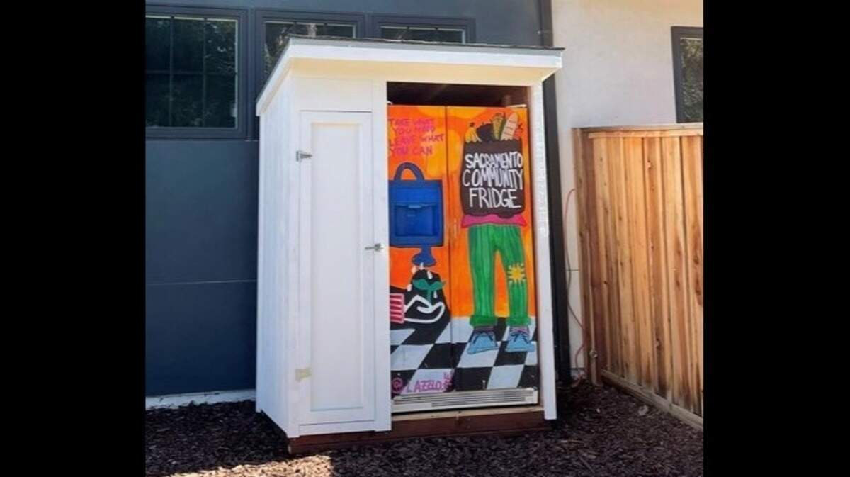 Oak Park resident Caity Maple in February put a refrigerator and food pantry in her side yard to give food away to others. The Sacramento city code does not allow residents to store refrigerators outdoors.