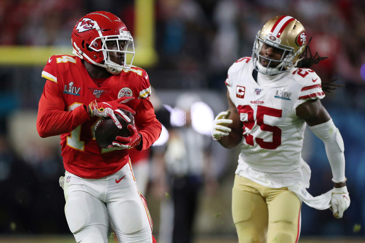 Kansas City Chiefs receiver Sammy Watkins, left, runs for yardage as 49ers cornerback Richard Sherman pursues during Super Bowl LIV on Feb. 2 in Miami Gardens, Fla.