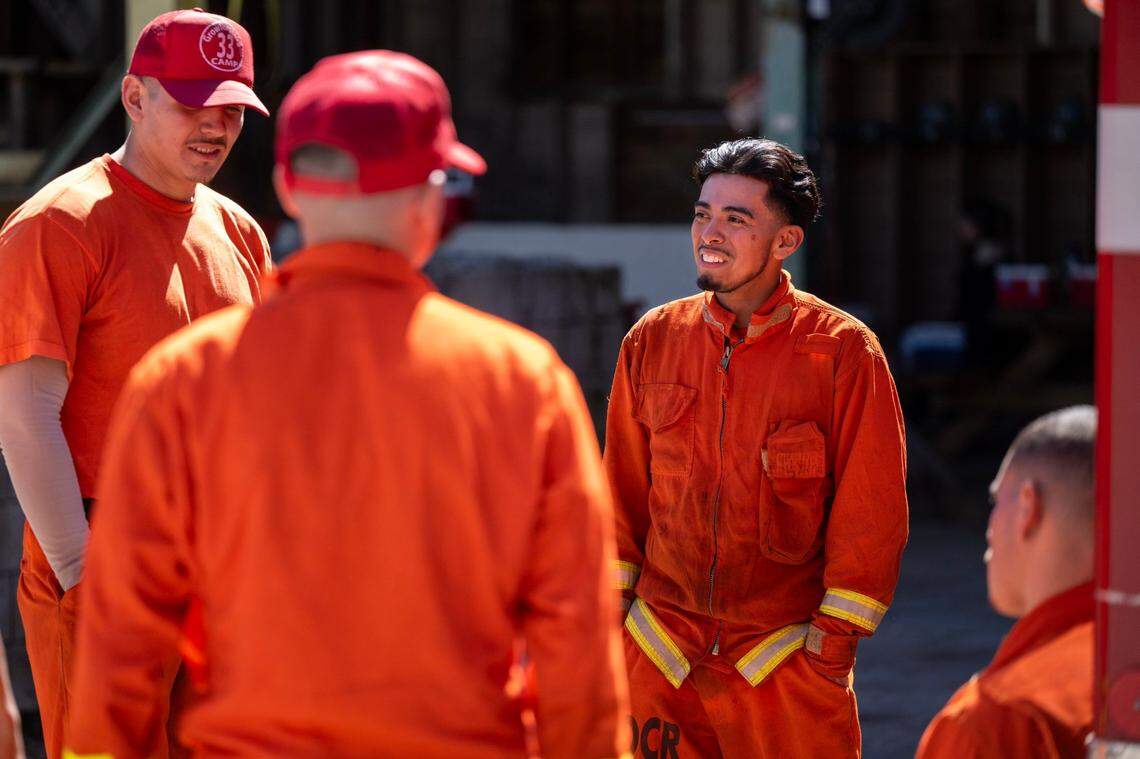Cal Fire inmate fire fighter Branden Lerma, 23, right, talks with Crew 5 team members after cutting a fire break at the Growlersburg Conservation Camp in Georgetown in March.