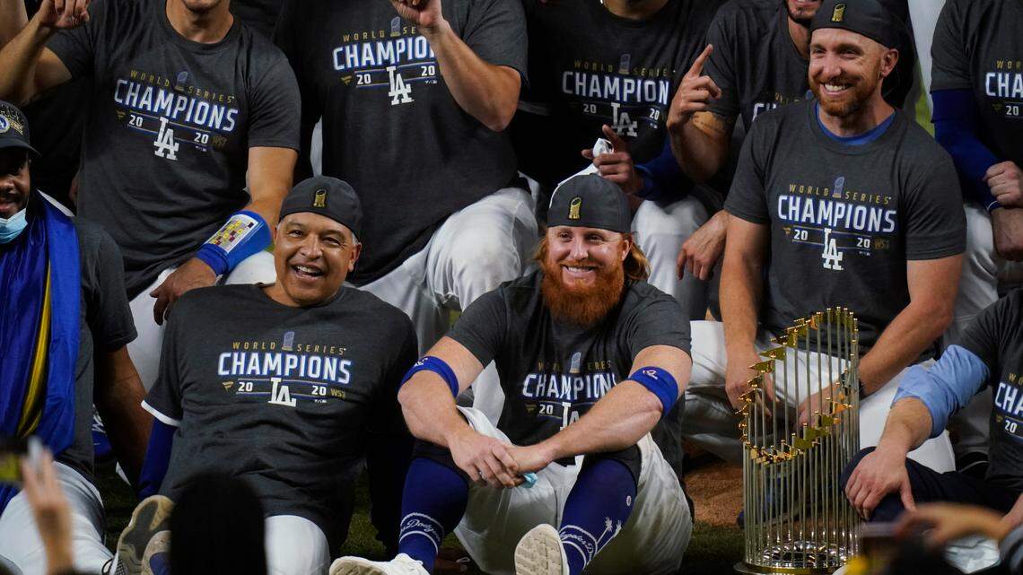 Los Angeles Dodgers manager Dave Roberts and third baseman Justin Turner pose for a group picture after the Dodgers defeated the Tampa Bay Rays 3-1 in Game 6 to win the baseball World Series, Tuesday, Oct. 27, 2020, in Arlington, Texas. (AP Photo/Eric Gay)