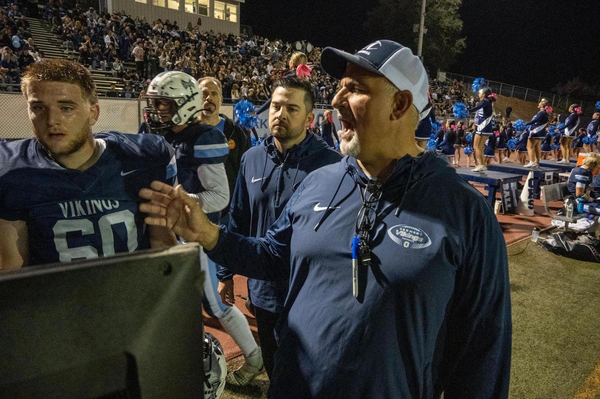 Oakmont Vikings head coach Jake Messina talks with lineman in the second half in Friday’s game against the Marysville Indians’ on Friday. 