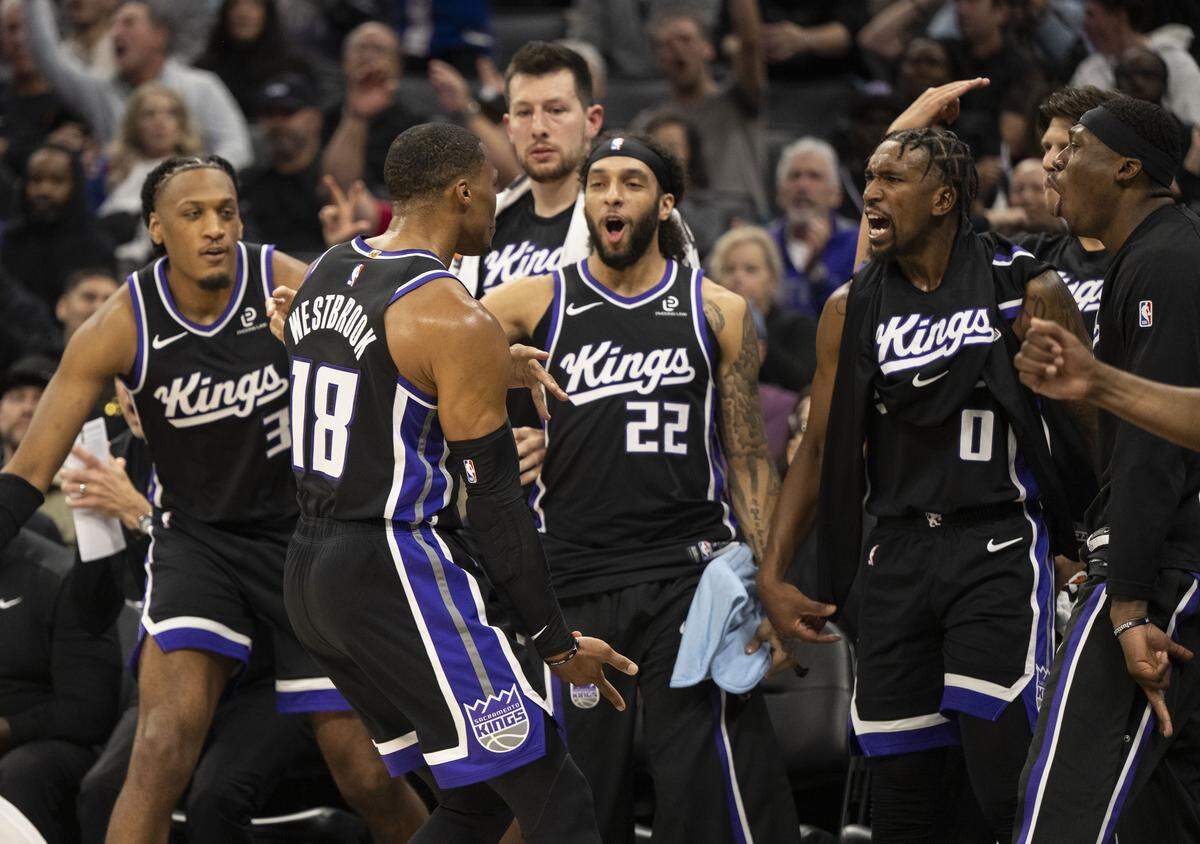Sacramento Kings guard Russell Westbrook (18) celebrates a three-point basket with teammates during an NBA game at Golden 1 Center on Sunday.