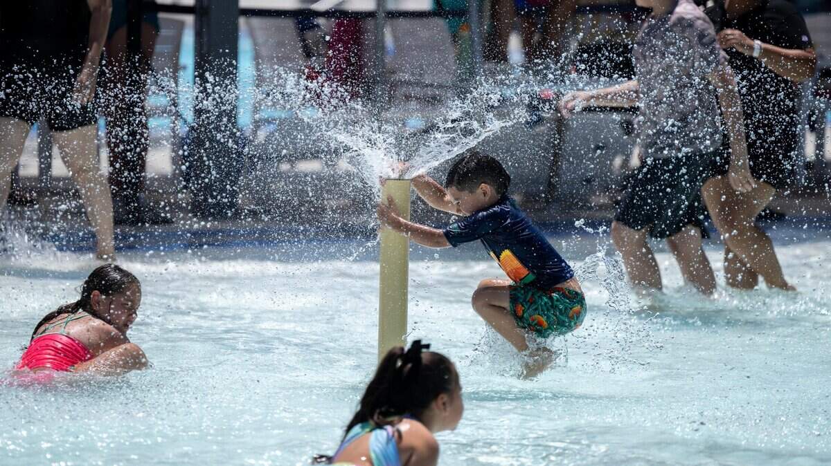 Children play in the pool at the North Natomas Aquatic Complex in Sacramento in July 2024. Sacramento’s city-operated pools will offer $2 admission this weekend as the city kicks off the summer swim season amid triple-digit temperatures.