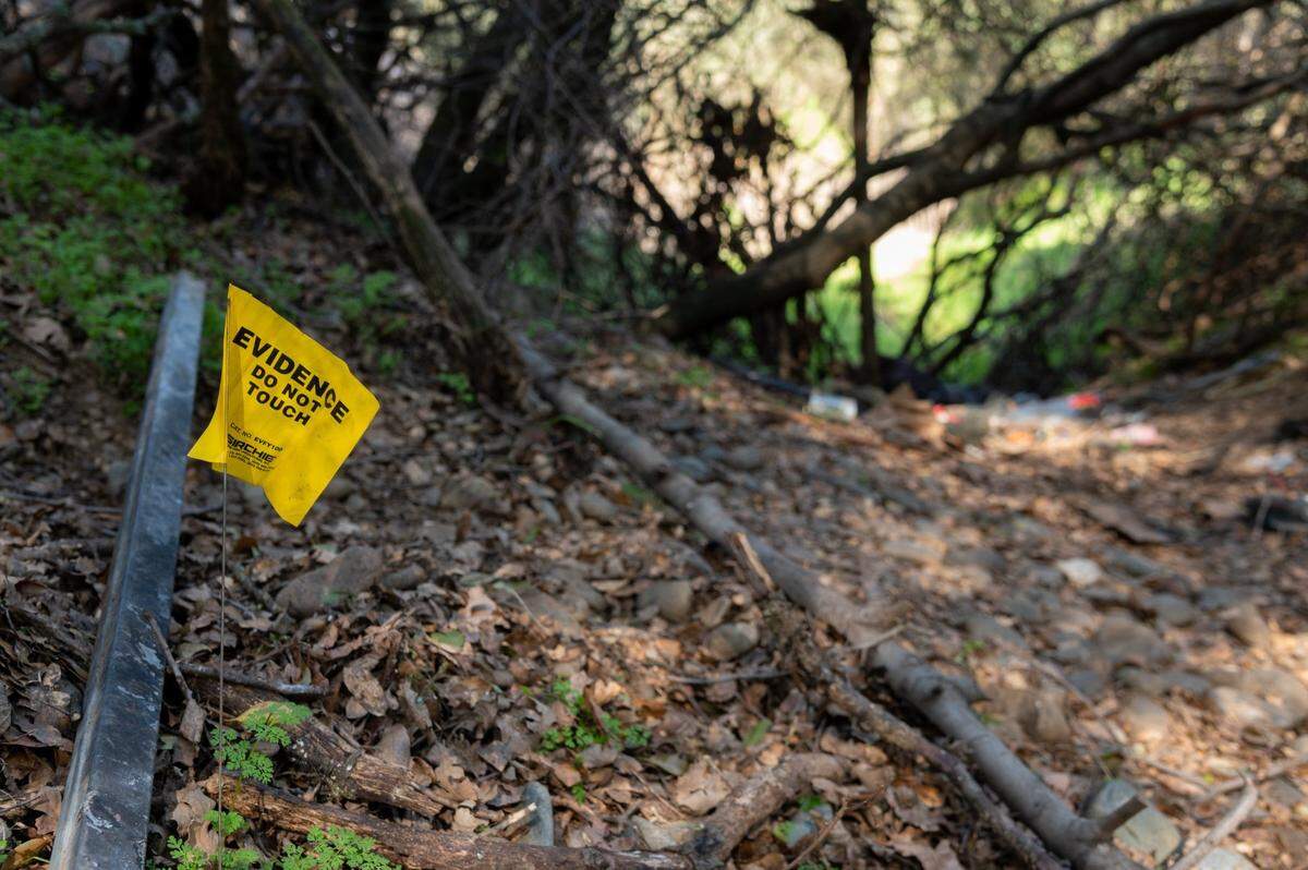 A tag marks evidence on Monday at the camp site of Mikilo Rawls, where the body of Emma Roark, 20, was found in the American River Parkway near Rancho Cordova. Rawls, 37, who was arrested Friday after DNA tied him to the crime, now faces charges of murder with three special circumstances that could lead to prosecutors seeking the death penalty, according to court documents.