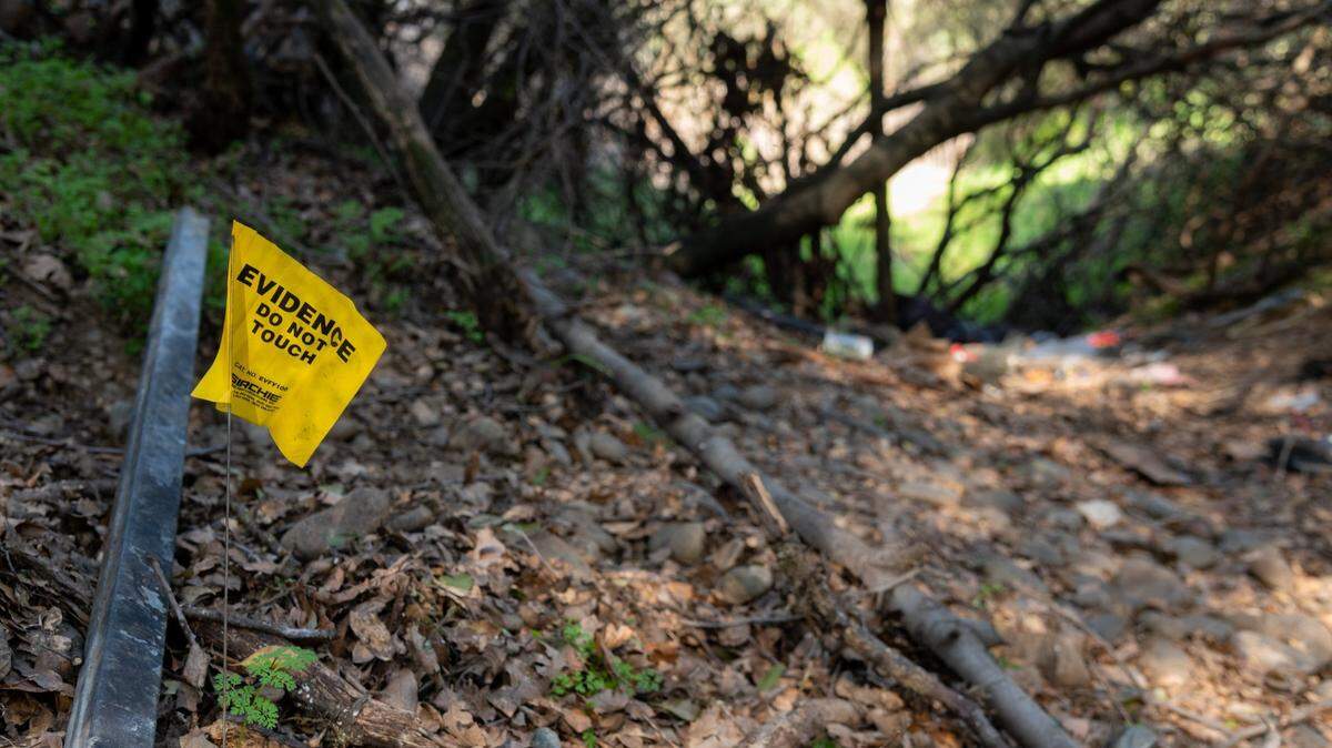 A tag marks evidence on Monday, Feb. 14, 2022, at the camp site of Mikilo Rawls where the body of Emma Roark, 20, was found in the American River Parkway near Rancho Cordova.