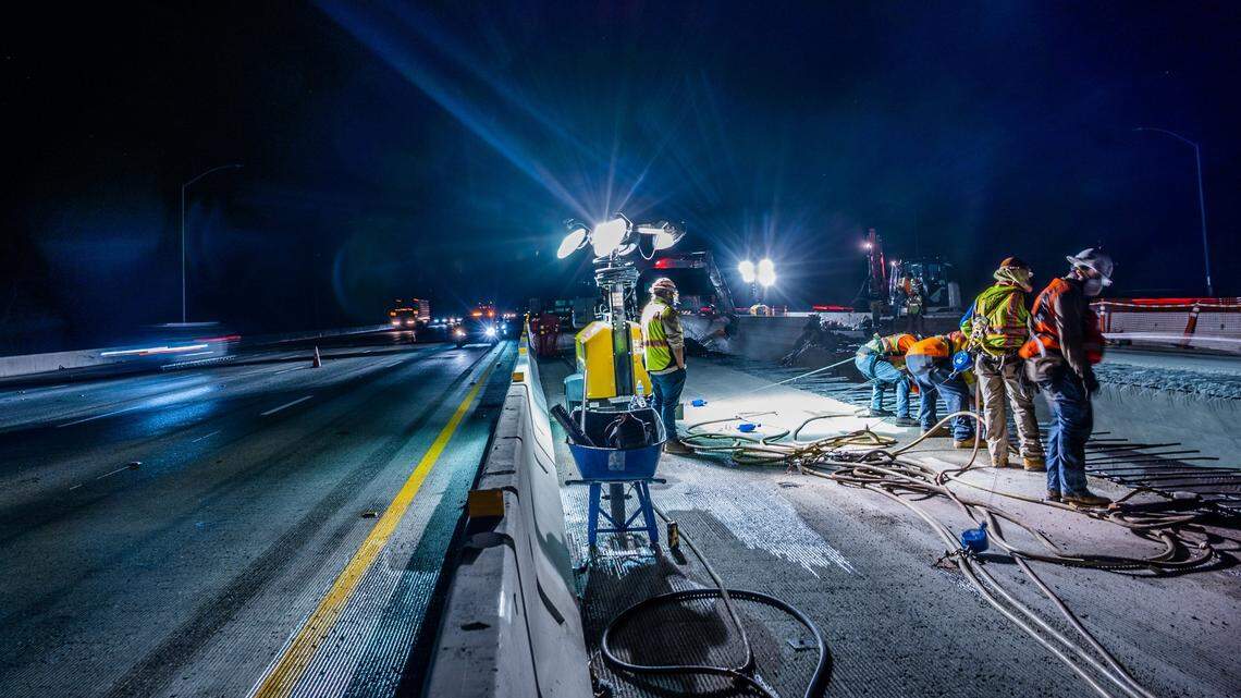 Cars on the freeway drive by the W-X freeway construction project in Sacramento on Thursday, May 20, 2021.