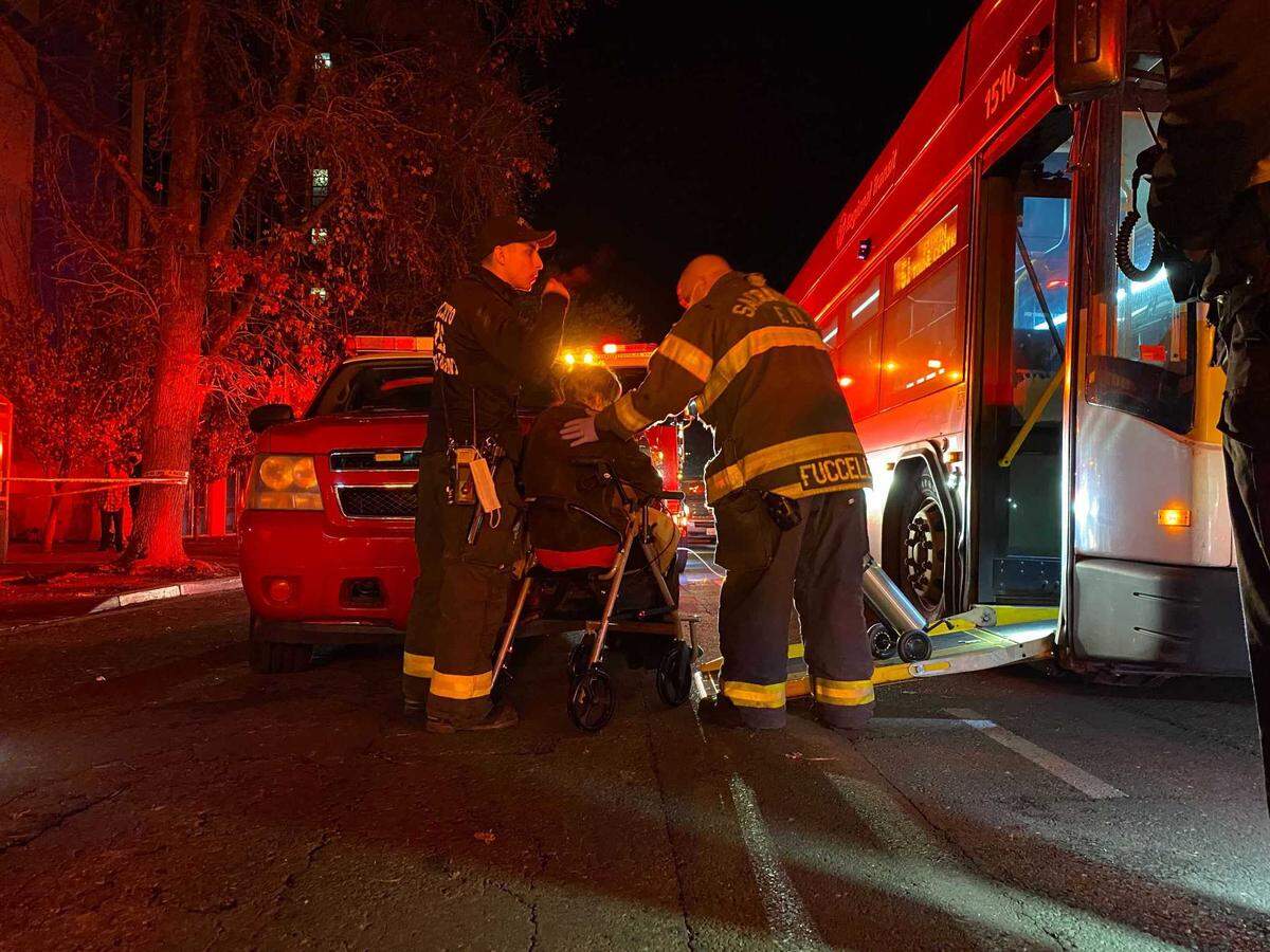 Residents of the Edgewater senior apartment tower in downtown Sacramento are evacuated by Sacramento Fire Department personnel on Tuesday, Dec. 14, 2021. The Edgewater was evacuated several hours after power to the building was severed by a nearby substation fire.