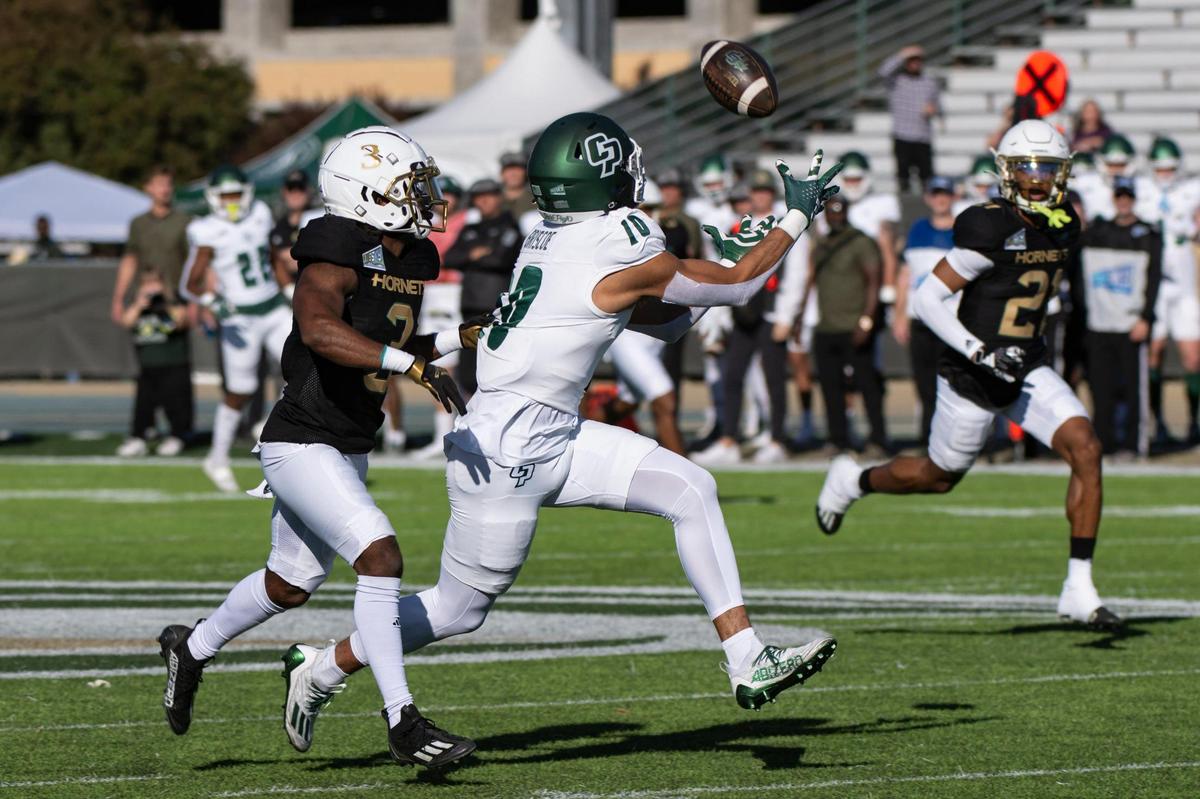 Cal Poly Mustangs wide receiver Michael Briscoe (10) makes a 47-yard pass reception over Sacramento State Hornets cornerback Dilon Juniel (3) to set up a field goal in the first half of the NCAA football game at Hornet Stadium on Saturday, Nov. 11, 2023.