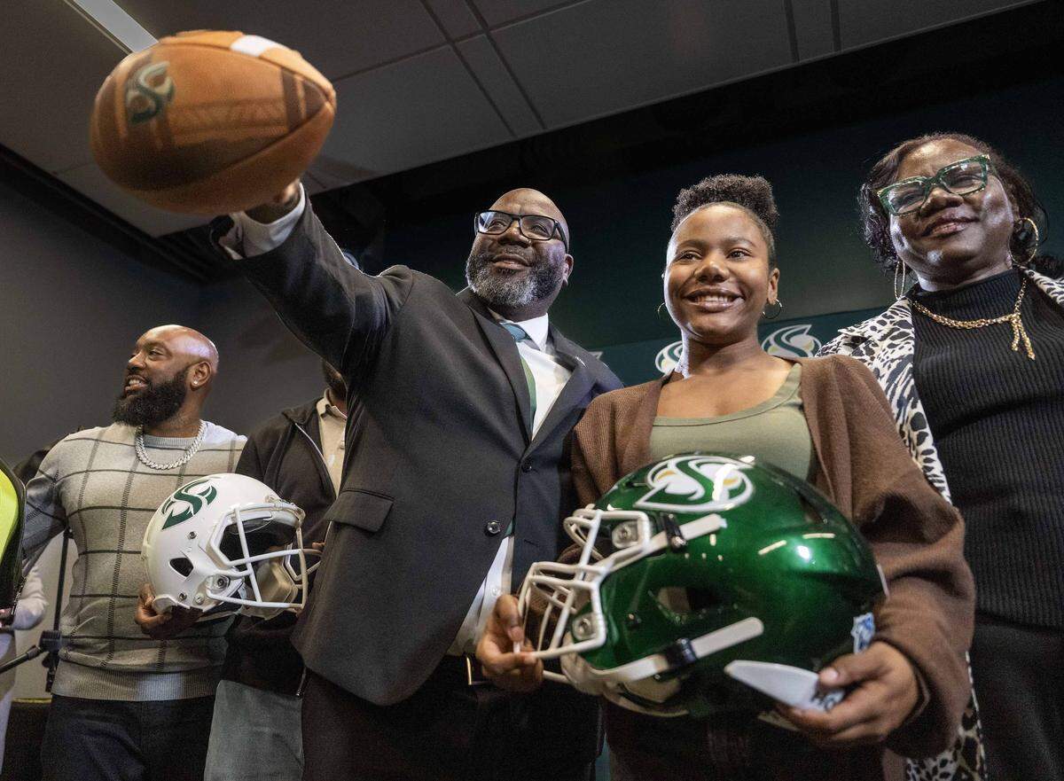 Sacramento State football coach Alonzo Carter is joined by, from left, his son Alonzo Carter II, daughter Kennedie and sister Michelle L. Myles Chambers during his introductory news conference at the university on Thursday.