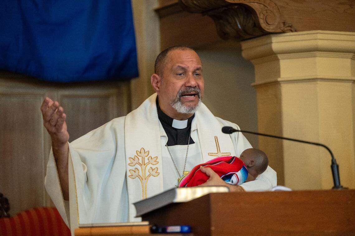 The Rev. Nelson Rabell-González, pastor of Iglesia Luterana Santa María Peregrina church in Stockton, cradles a Black baby Jesus while observing Día de la Candelaria, or the celebration of the presentation of Jesus at a temple in Jerusalem, on Feb. 2.