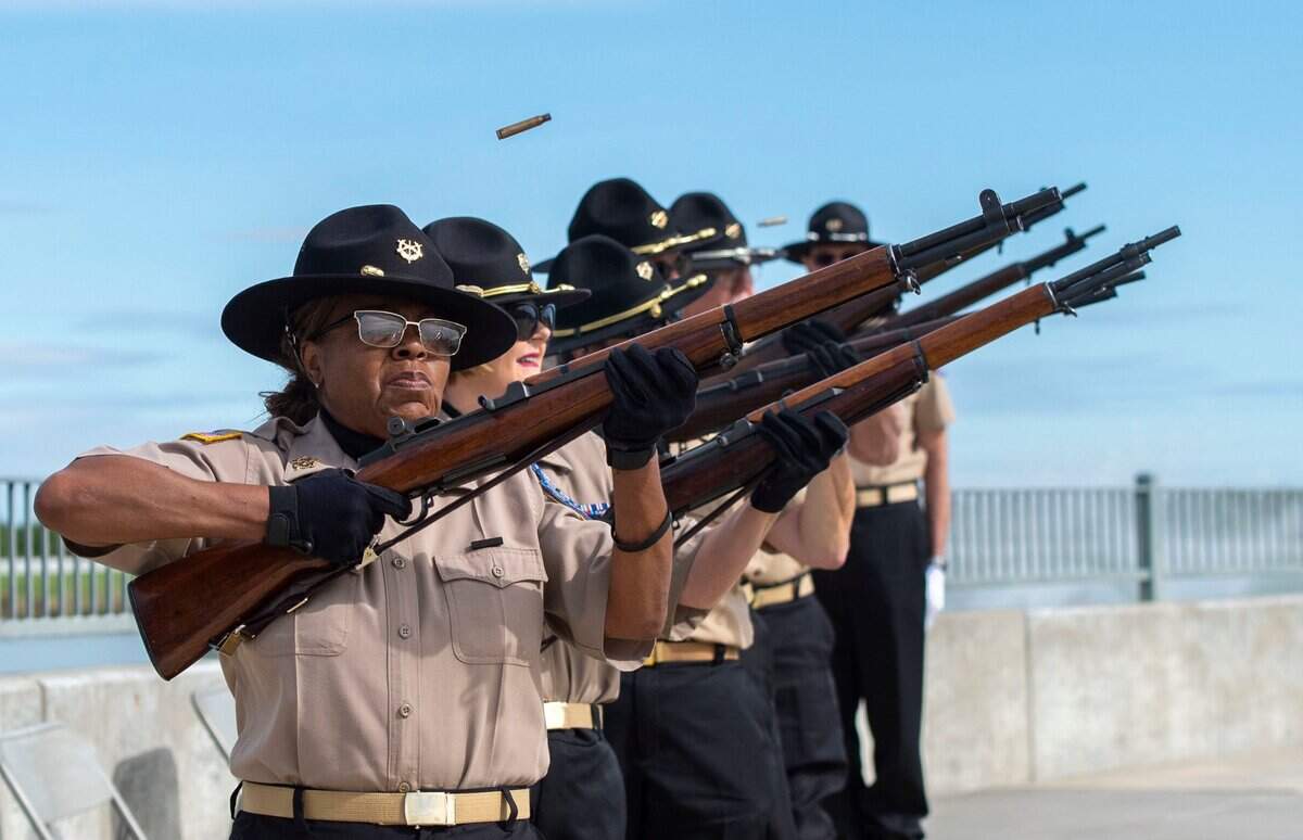 Nel Sweet-Davis, left, and other members of the Service Veterans of Northern California Volunteer Honor Guard perform a rifle salute during the Memorial Day ceremony at the Sacramento Valley National Cemetery in Dixon on Saturday.
