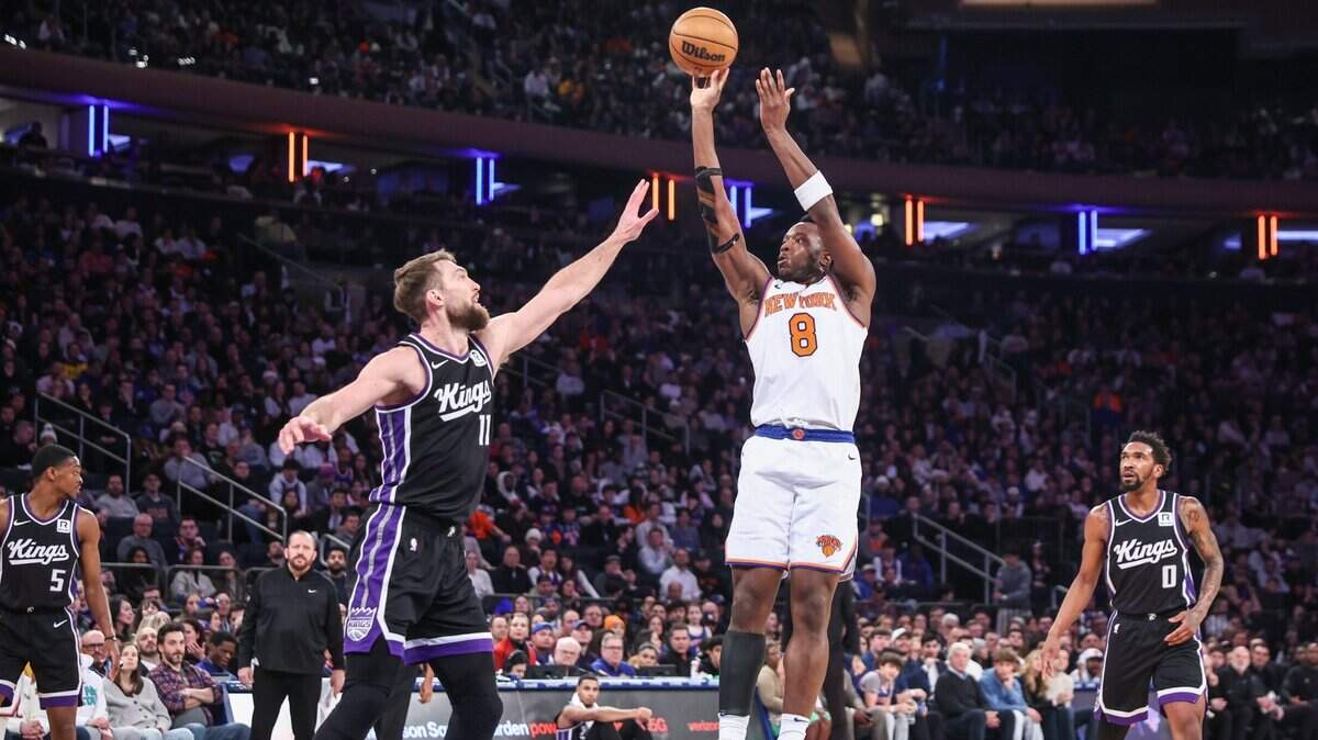 Jan 25, 2025; New York, New York, USA;  New York Knicks forward OG Anunoby (8) shoots the ball against Sacramento Kings forward Domantas Sabonis (11) in the second quarter at Madison Square Garden. Mandatory Credit: Wendell Cruz-Imagn Images