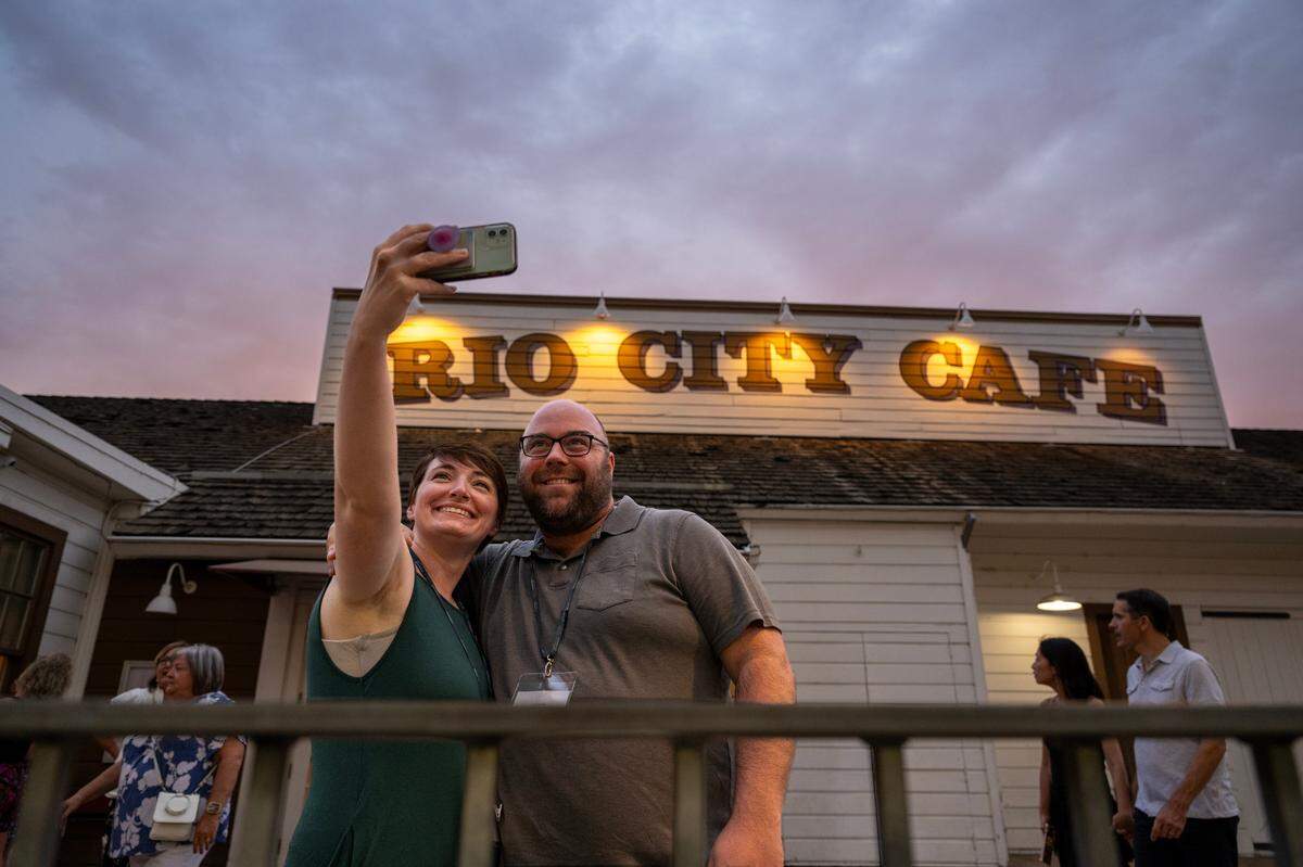 Ryan and Adrienne Newcomer, visiting from St. Louis, Mo., take their photograph outside the Rio City Cafe in Old Sacramento on Friday.