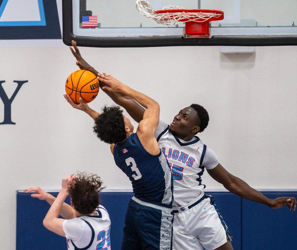 The Destiny Christian Lions’ Jephte Tambala (15) blocks the shot attempted by the Clayton Valley Charter Ugly Eagles’ Vince Ellis (3) in the first half of the CIF Northern California Division Il semifinal game on Saturday.