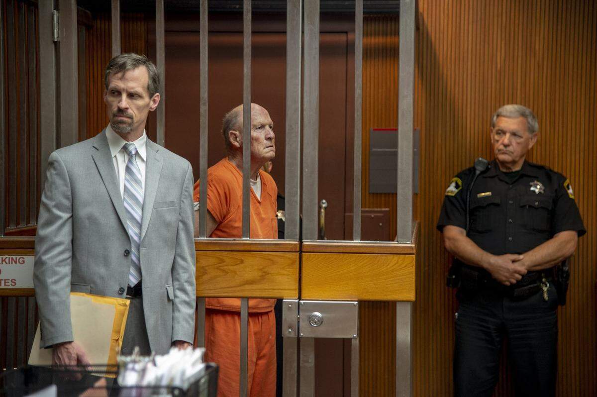 East Area Rapist Joseph James DeAngelo appears in an arraignment cell in Sacramento Superior Court in 2018 while defense attorney Joe Cress and a Sheriff’s deputy stand nearby.