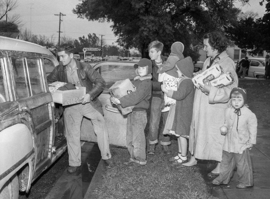 A Marysville family loads belongings into their car in preparation to move out of the city on Dec. 23, 1955, when it was feared it would be inundated.