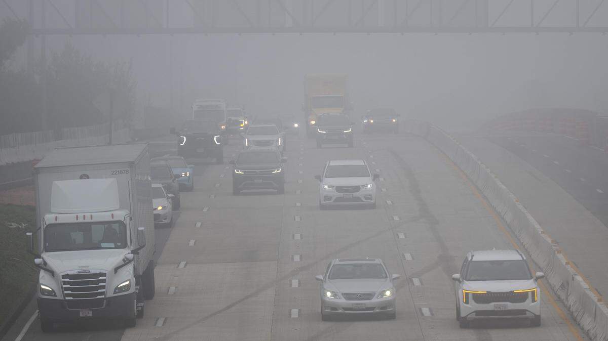 Vehicles with their headlights on drive west in the fog on Highway 50 in Sacramento on Monday morning, Dec. 29, 2025.