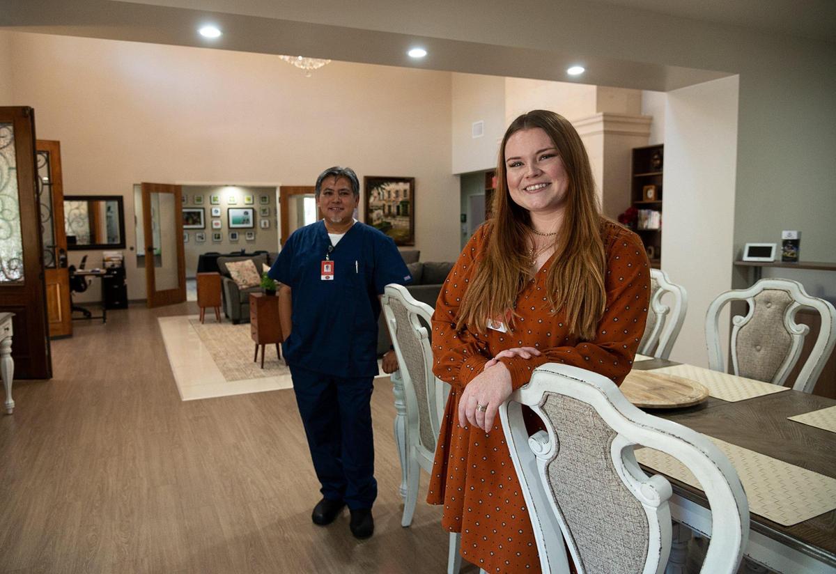 Grace Hawkins, clinical and community liaison, and administrator Ron Ordona stand in the dining room of Quiescence Care Home on July 6, 2021 in Foothill Farms. The congregate living health facility is partially owned by the nurses who work there.