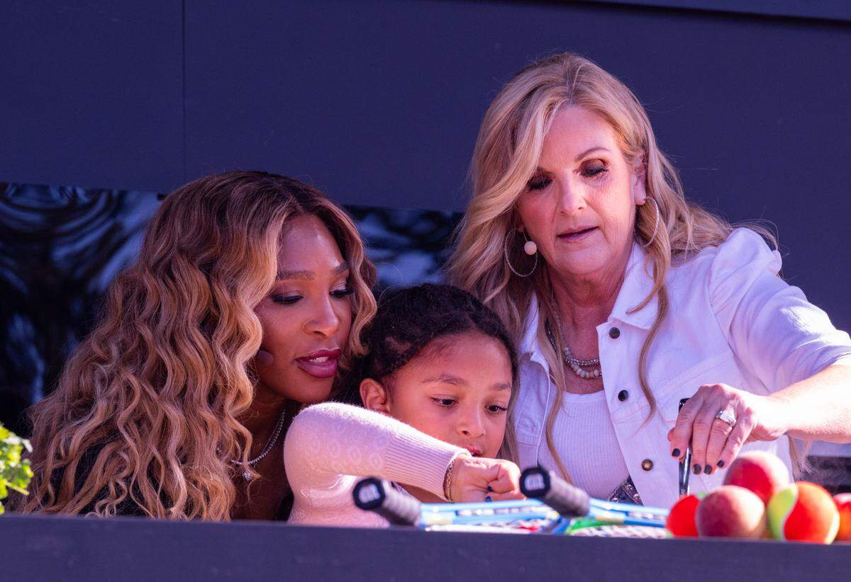 Tennis star Serena Williams, left, her daughter Olympia, and county music star Trisha Yearwood stir a dish during cooking demonstration at the BottleRock music festival in Napa on Friday, May 23, 2025. 