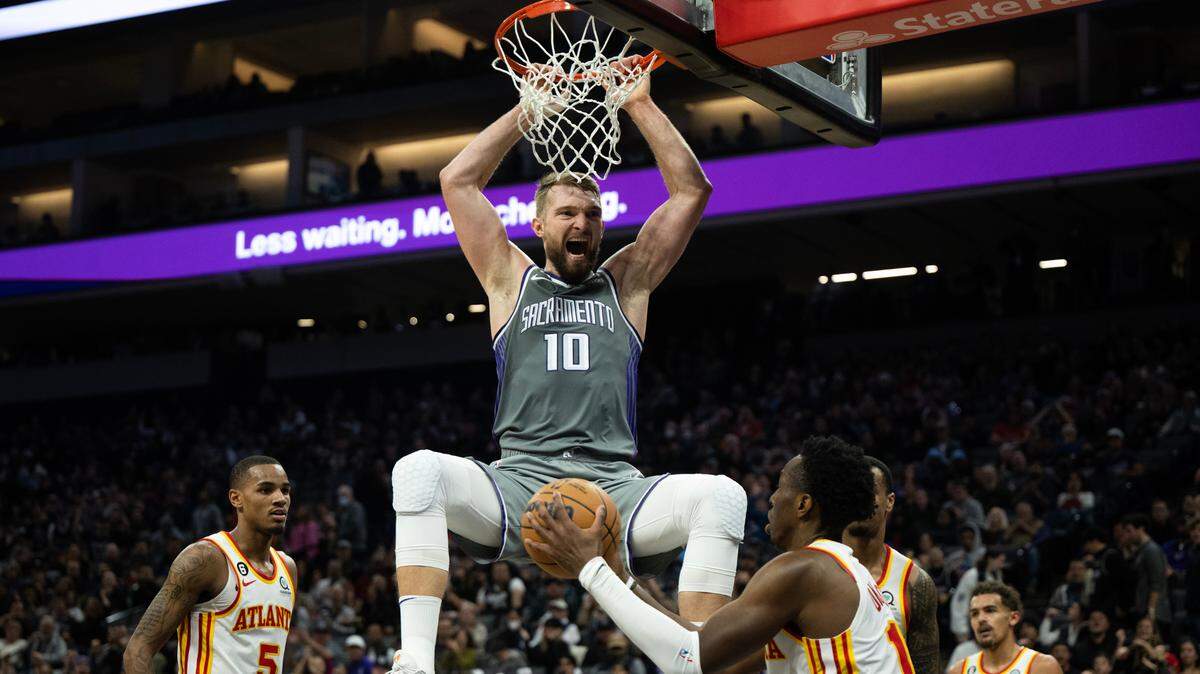 Sacramento Kings forward Domantas Sabonis (10) reacts after dunking the ball over Atlanta Hawks forward Onyeka Okongwu (17) during a game at Golden 1 Center in Sacramento, Wednesday, Jan. 4, 2023.