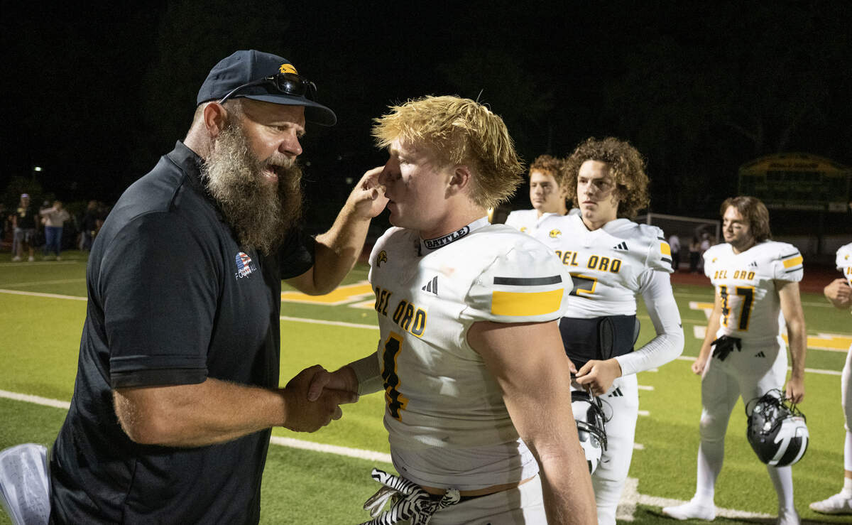 Del Oro Golden Eagles head coach Josh Parry shakes hands with Brock Sherman following the game against the Placer Hillmen on in September in Auburn.