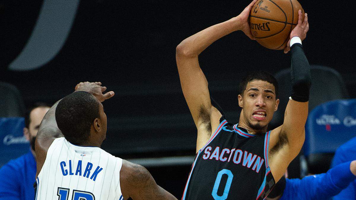 Sacramento Kings guard Tyrese Haliburton (0) looks for open player to pass to guarded by Orlando Magic forward Gary Clark (12) in the first quarter during a game at Golden 1 Center on Friday, Feb. 12, 2021 in Sacramento.