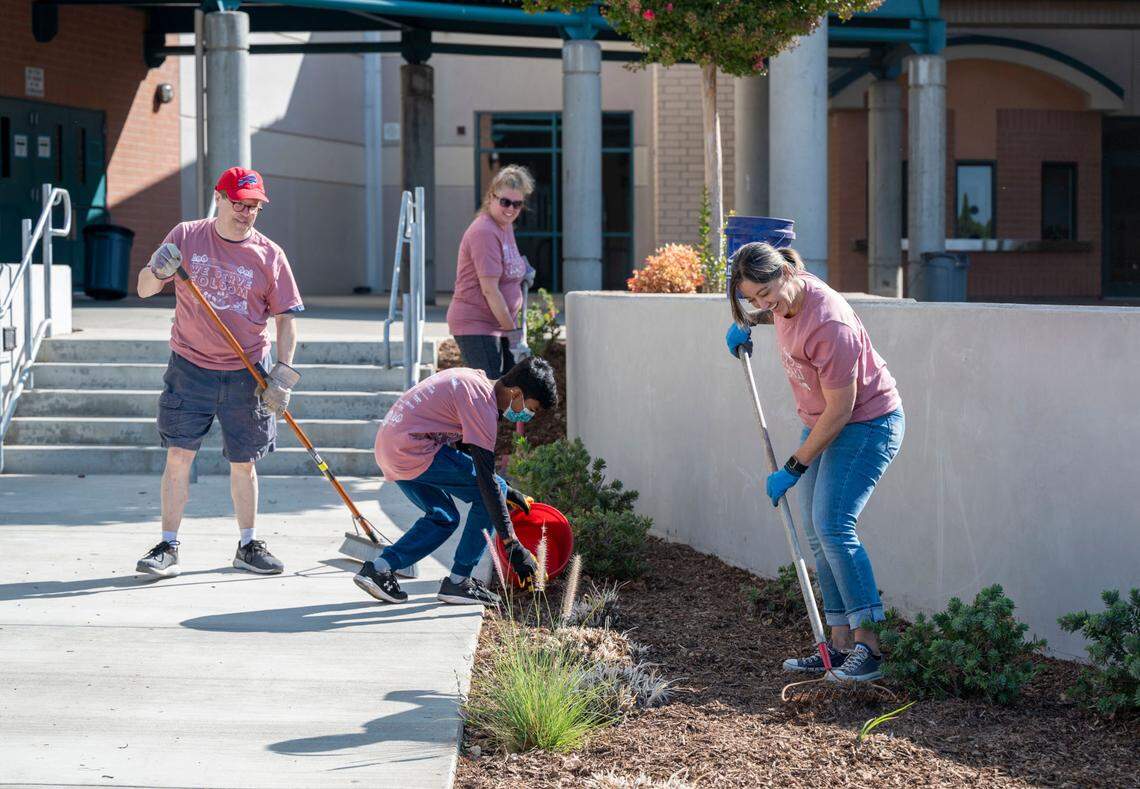 Jen Tarbox, right, who is a parent running for Folsom Cordova Unified school board, rakes mulch while helping to beautify Folsom High School during the Folsom Community Service Day on Sept. 17. School board member David Reid, left, and his wife Karen Reid, center, work alongside Tarbox along with Folsom High freshman Sahith Borige, 14.