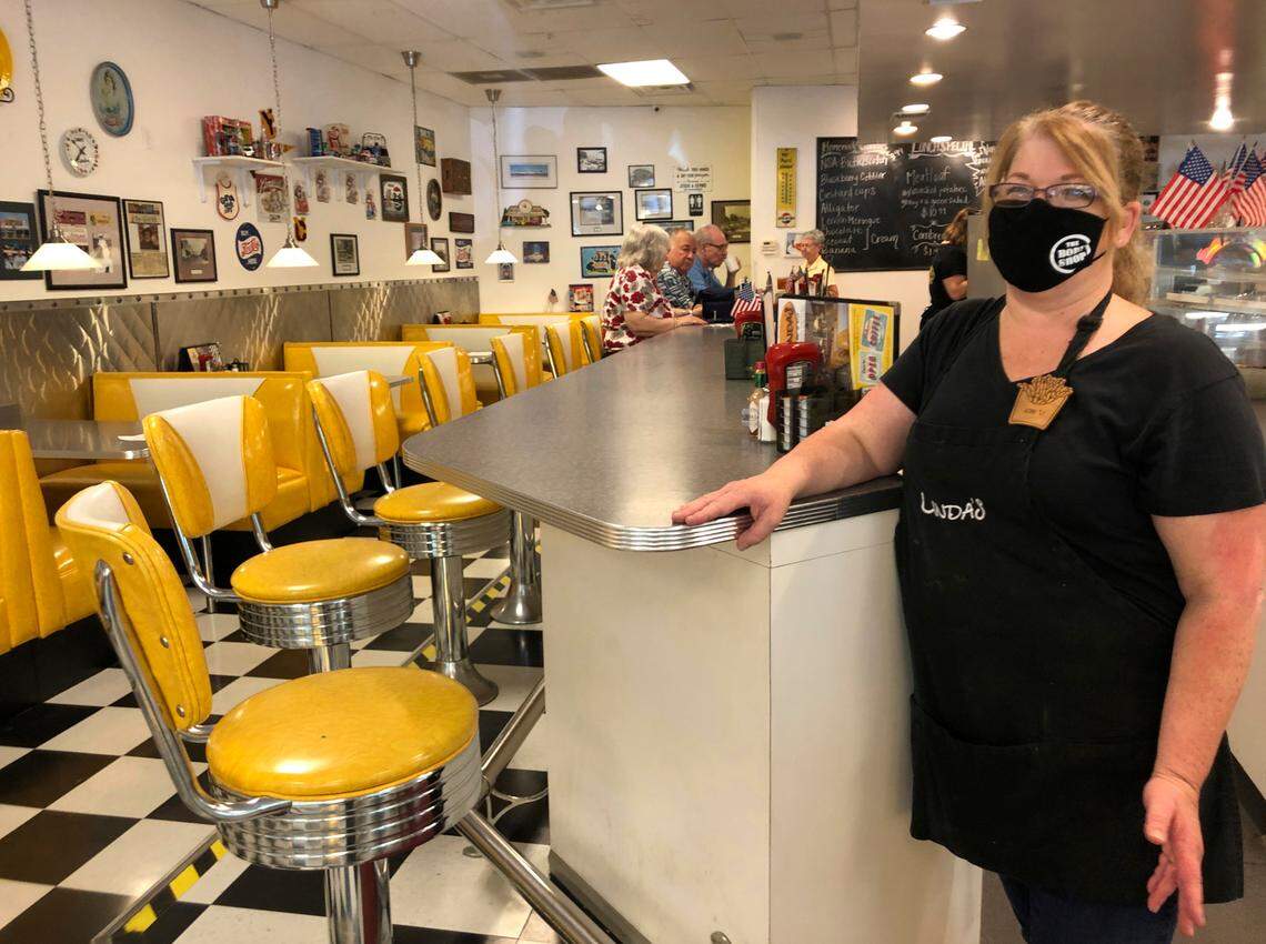Restaurant manager Lori Pack stands at the counter of Linda’s Soda Bar and Grill in Yuba City on Thursday, July 9, 2020. Sutter County was one of the first counties to reopen its economy when it defied Gov. Gavin Newsom’s stay-at-home order in May to allow restaurants, hair salons, gyms and shopping malls to reopen. But Thursday, the county was added to a state watch list because of its rising number of coronavirus cases and hospitalizations. That will eventually trigger another round of restrictions, forcing bars to close and indoor operations to cease at restaurants and other public places for three weeks. Pack says the restaurant tried takeout-only service for three weeks earlier this year during the coronavirus pandemic. But she said it was “just not sustainable.”