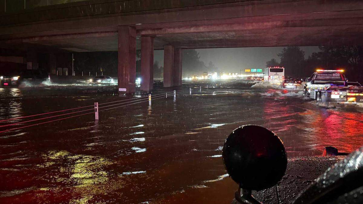 Flooding is seen Sunday night on Interstate 5 near the Hartnell Road overcrossing in Redding. One person was killed as flash flooding triggered water rescues and widespread road closures across Shasta County.