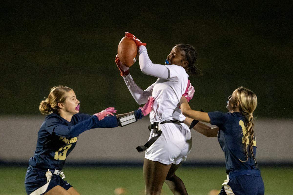 The McClatchy Lions’ London Lee (11) catches a pass before running for a touchdown past the West Park Panthers’ Kelly Lane (13) and Keira Taylor (10) in the second half of the CIF Sac-Joaquin Section Division I flag football championship game Saturday at Cosumnes River College in Sacramento.