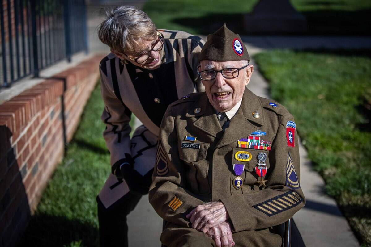 Army veteran Marvin D. Cornett laughs with his daughter Marleen Maltby at the American Legion Post 84 in Auburn after he received the Bronze Star medal and Purple Heart on Monday.