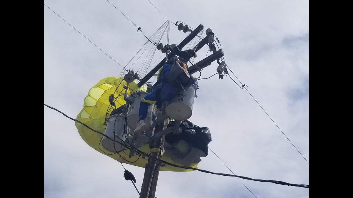 A skydiver became tangled in power lines after overshooting a landing field near Lake Elsinore, California firefighters say.