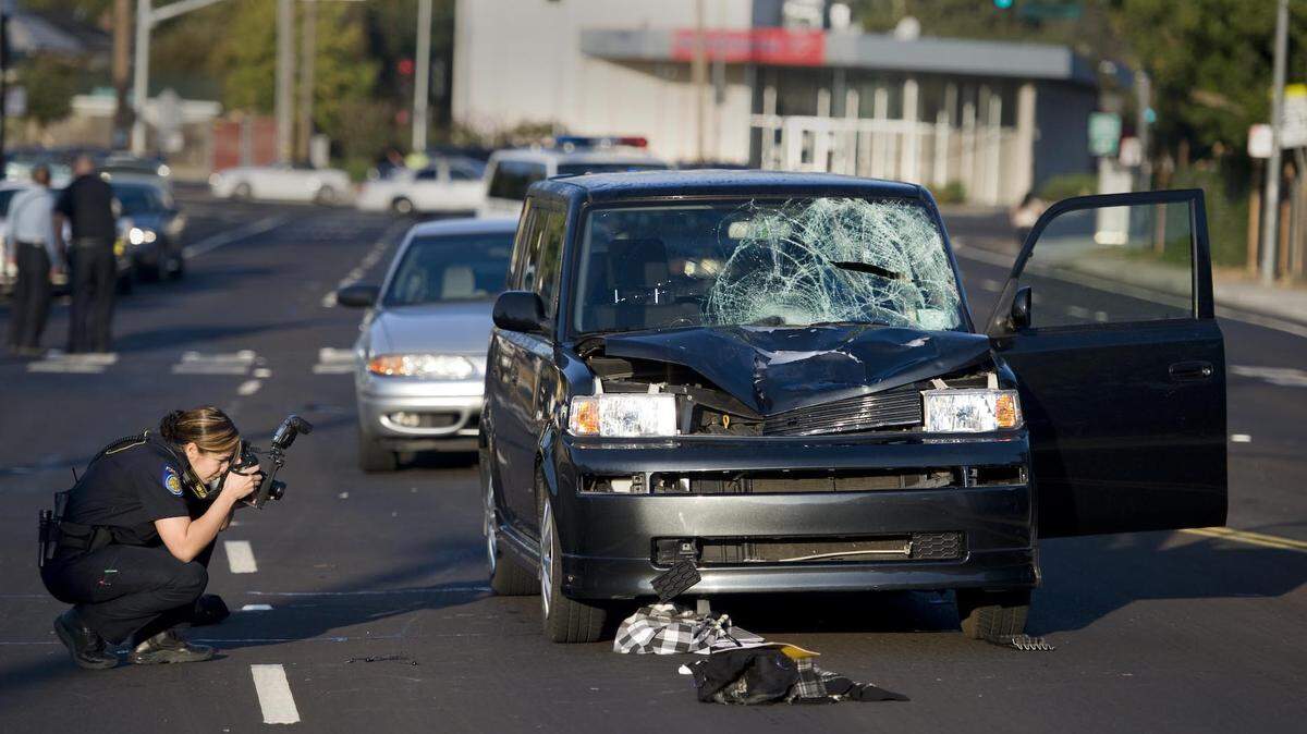 A Sacramento police officer takes pictures in 2010 of the scene where two female teens on their way to school were hit by a vehicle on Broadway east of Martin Luther King Jr. Boulevard, leaving them with serious injuries. The road was identified by the city as one of Sacramento’s five most dangerous corridors.