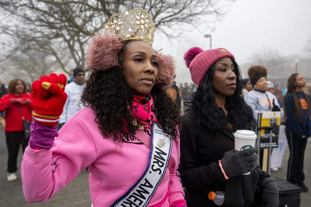 Iris Price and Liana Wright listen to a speaker before the Martin Luther King Jr. “Walk With Me” event at Sacramento City College on Monday. “Every culture should celebrate this day,” Price said. “This is a freedom for all of us to come together, remember the dream Dr. Martin Luther King Jr. had, and keep it alive by showing up and marching.”