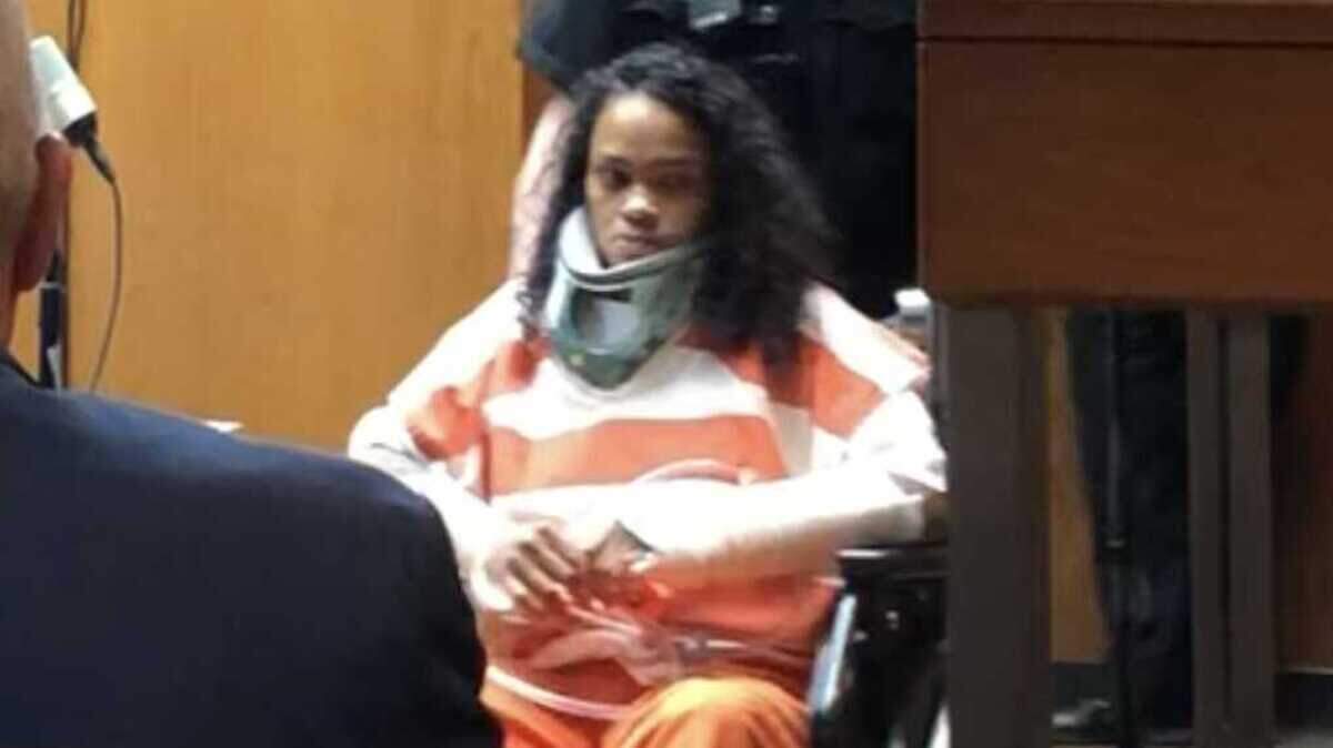 Precious Dawn Flowers, 28, right, in orange, is wheeled into Sacramento County Main Jail’s Department 62 for her arraignment on Tuesday, June 13, 2023. Flowers was charged with three counts of vehicular manslaughter and nine counts of child endangerment in connection with a crash on San Juan Road that killed three people on May 31.