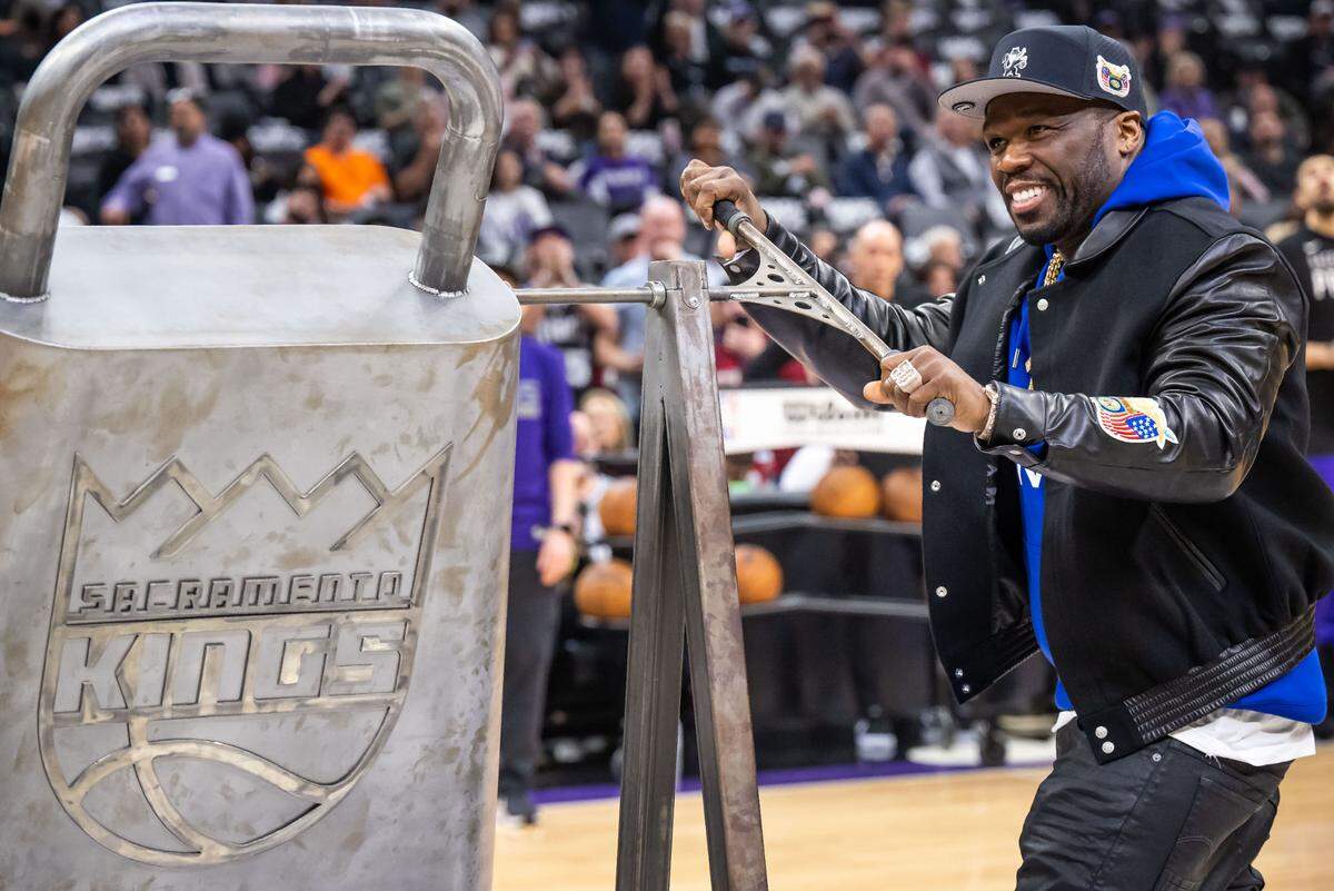 Grammy-winning rapper 50 Cent rings the giant cowbell before the Sacramento Kings play the Houston Rockets at the NBA basketball game Wednesday, Jan. 11, 2023, at Golden 1 Center in Sacramento.