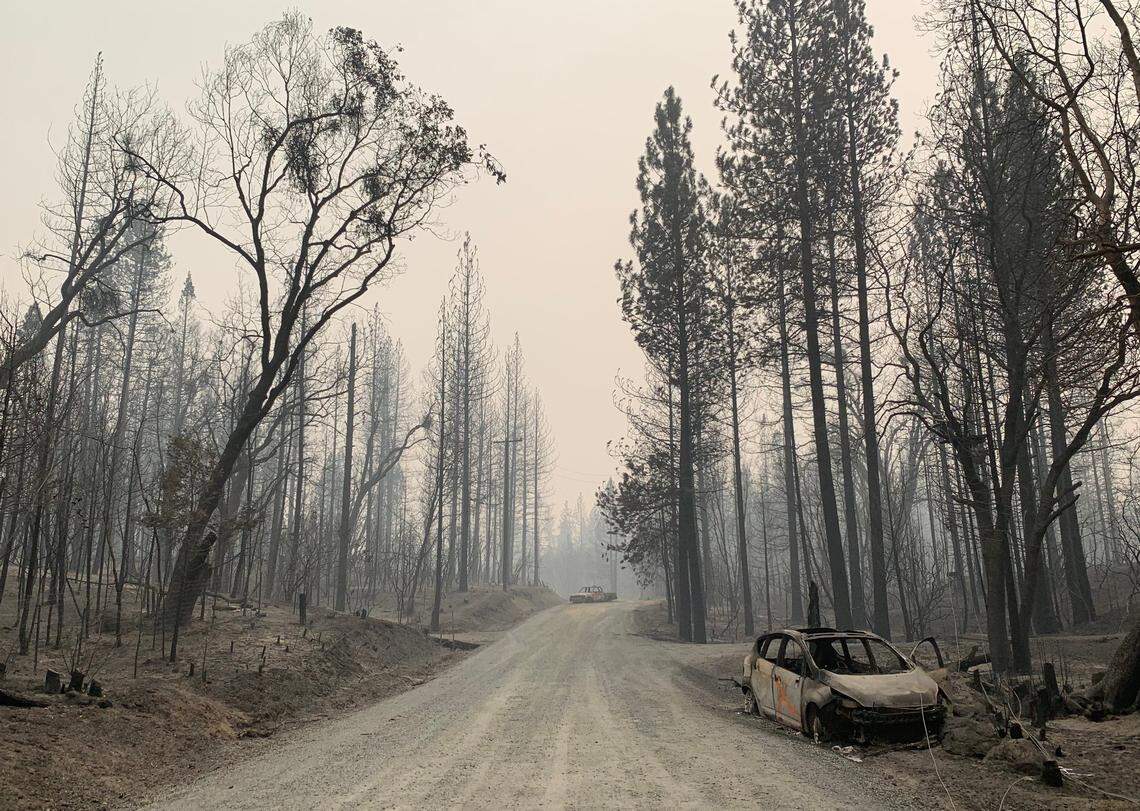 Two burned out vehicles sit on Graystone Lane in the aftermath of Bear Fire in Berry Creek on Thursday, Sept. 10, 2020.