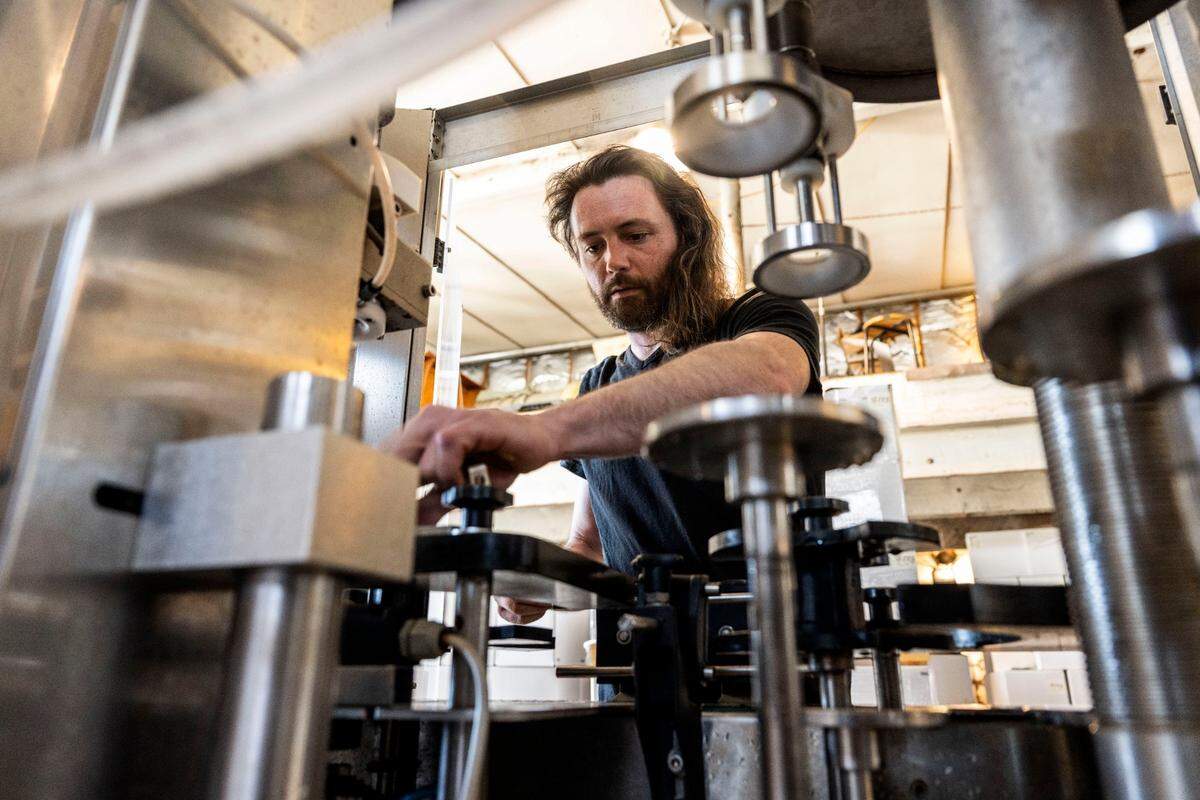 Alex Haarmeyer prepares a bottling line last month at Haarmeyer Wine Cellars in West Sacramento.