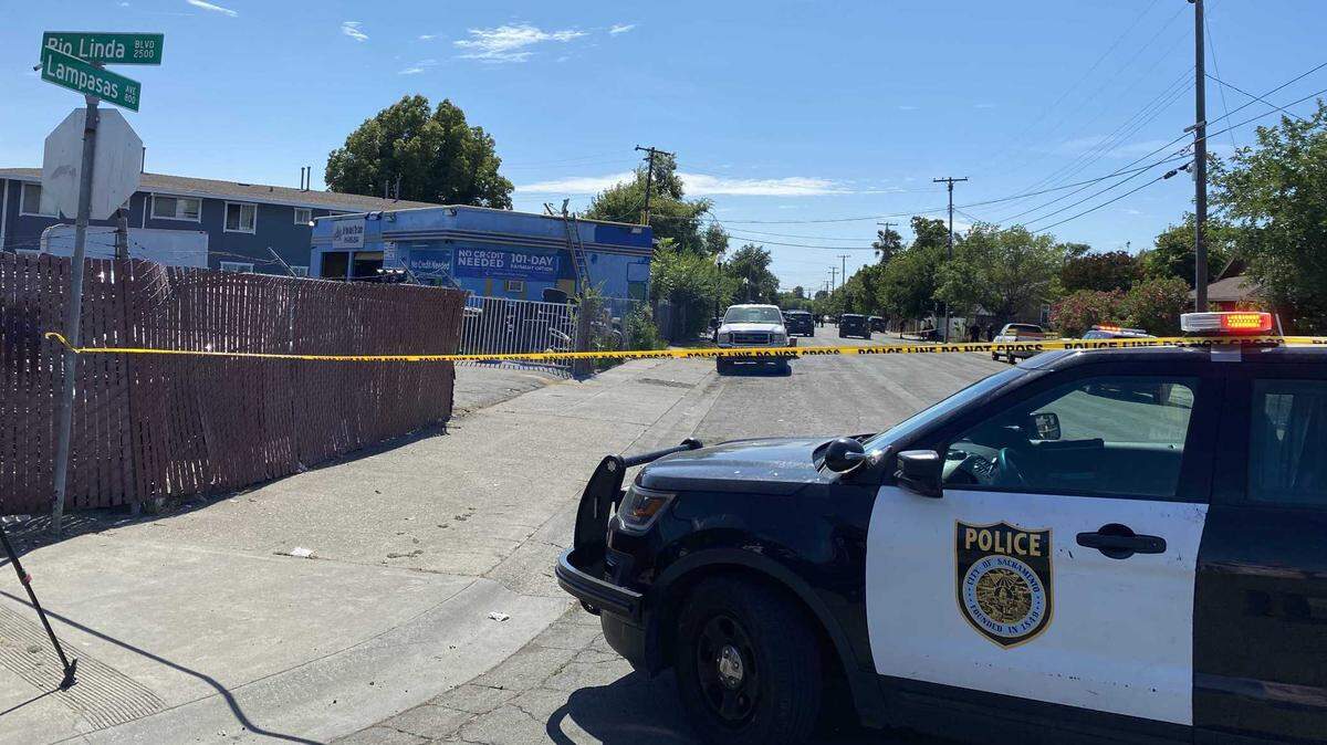 Sacramento police officers investigating a shooting on Monday, June 12, 2023, that killed two men in the 800 block of Lampasas Avenue in Sacramento, California.