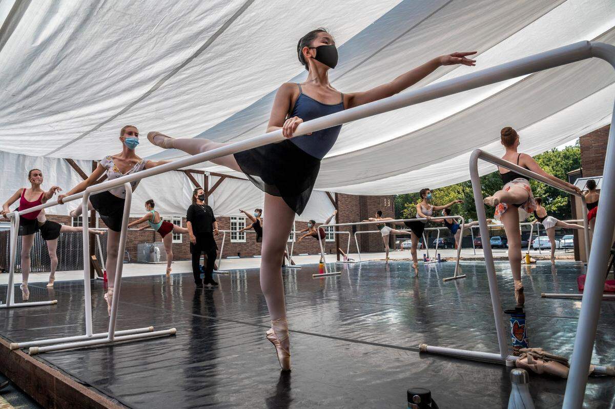 Maia Lee, 16, center, of Granite Bay, wears a mask and social distances during a trainee pointe class under the watchful eye of director Cynthia Dayer, left back, in a newly constructed outdoor studio on Thursday, Sept. 3, 2020 during the coronavirus pandemic. The School of Sacramento Ballet is adapting during the pandemic and now offering an outdoor ballet studio so some of their classes can dance in person.The pandemic has really made an emergency for that age group because we have to build and work so intensively to make the hurdle into the professional dance world, Drayer said. “This is a huge blessing that we can offer this.”