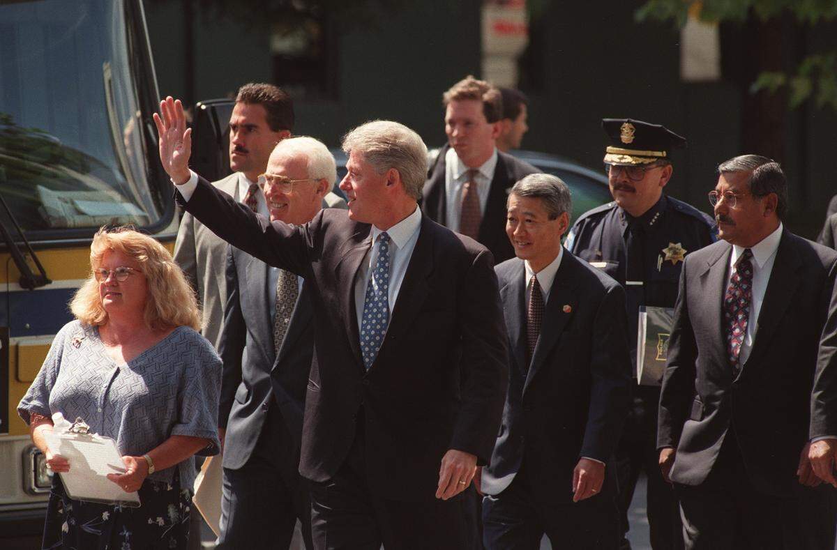 President Bill Clinton arrives in Sacramento, followed by Congressman Vic Fazio, Congressman Robert Matsui, Sacramento Police Chief Arturo Venegas, and Sacramento Mayor Joe Serna.