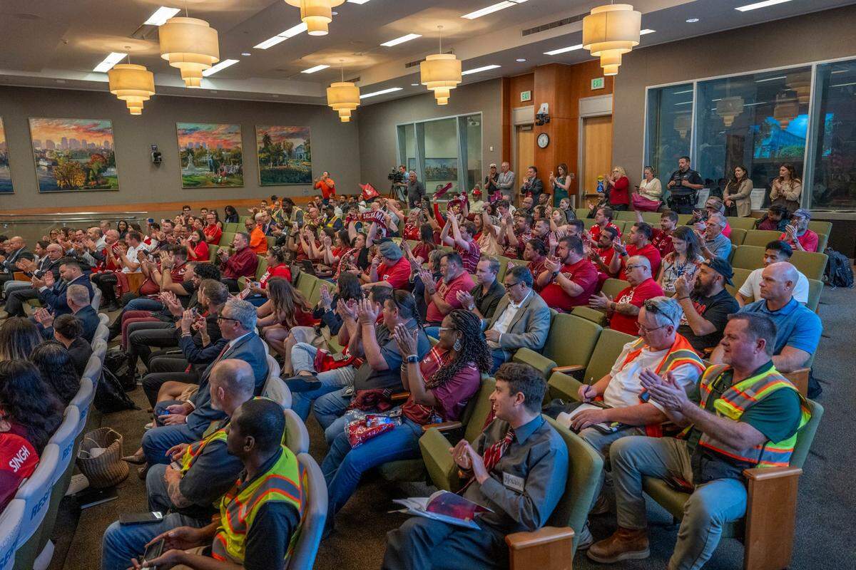 Members of the public celebrate Tuesday after the Sacramento City Council approved two resolutions that will allow construction of a Railyards soccer stadium.